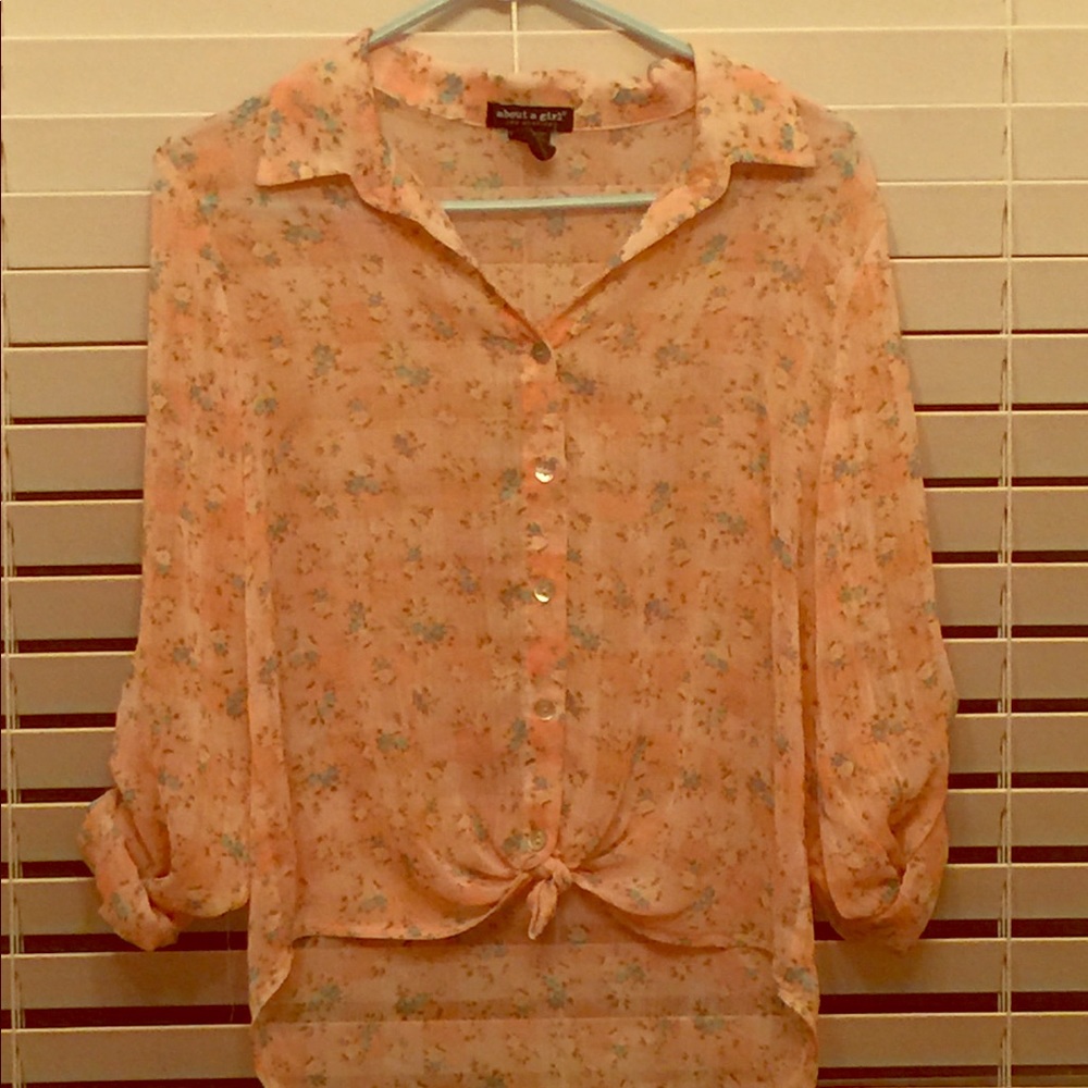 About A Girl pink somewhat see through shirt.